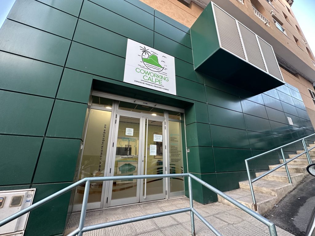 Fachada verde de Coworking Calpe con el rótulo de entrada